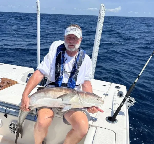 John Hardy holding a fish on a boat